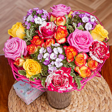 Beautiful Roses in colours of orange, yellow and pink are surrounded by clusters of delicate purple Sweet William, resulting in a simply stunning summer arrangement.<br/><br/>Framed with green foliage and presented in a lovely rattan holder, this posy needs no arranging and will make a wonderful gift for a loved one. Beautiful Roses in colours of orange, yellow and pink are surrounded by clusters of delicate purple Sweet William, resulting in a simply stunning summer arrangement.<br/><br/>Framed with green foliage and presented in a lovely rattan holder, this posy needs no arranging and will make a wonderful gift for a loved one.